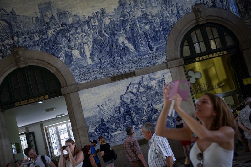 Tourists visit the Sao Bento railway station, in Porto July 25, 2016. u00e2u20acu201d AFP pic