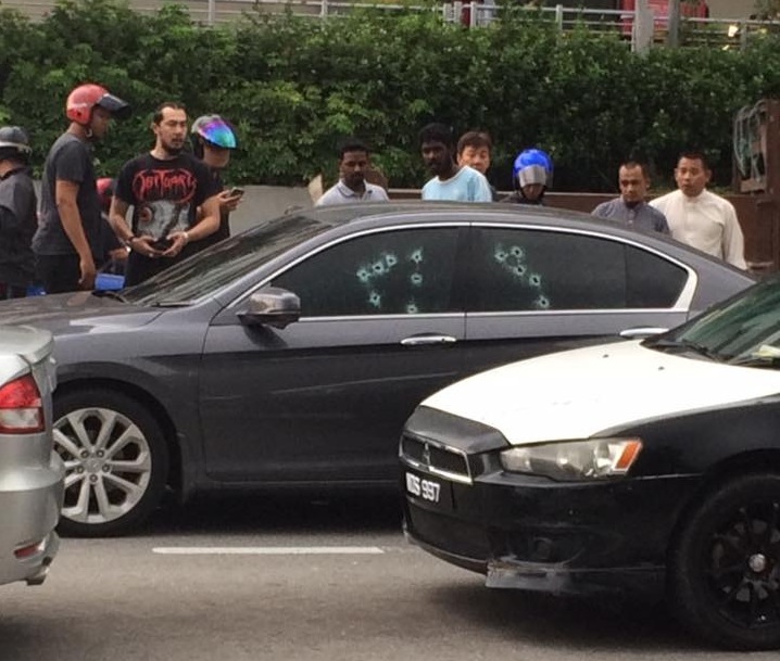 The victim's car, riddled with bullet holes from some 20 shots fired by two unknown gunmen who killed the 43-year-old driver when he stopped for a red light in Setapak, Kuala Lumpur July 27, 2016
