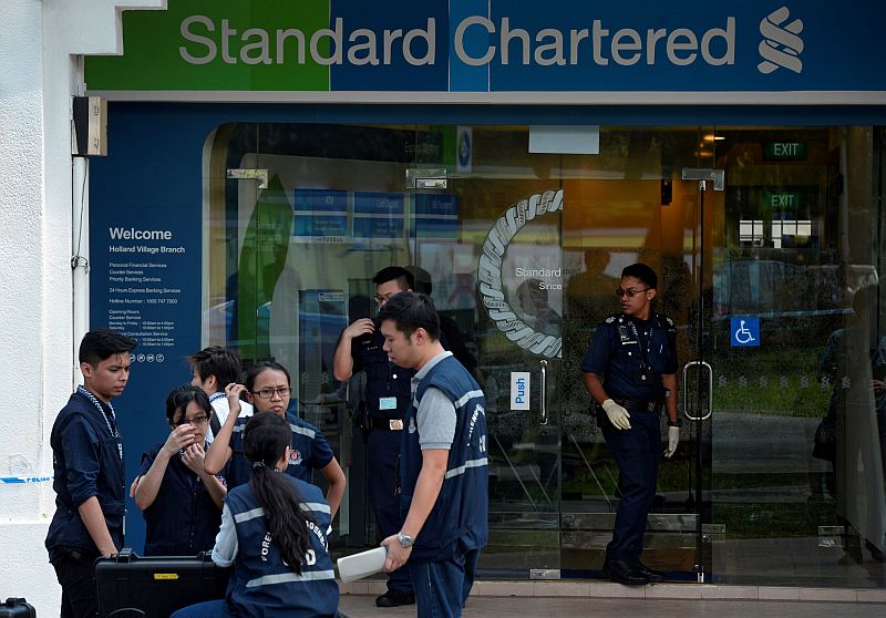 Police officers work at scene of a robbery at Standard Chartered Bank branch in Holland Village, Singapore July 7, 2016. u00e2u20acu201d Reuters pic