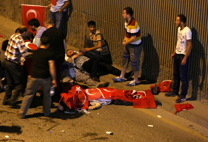 People react as bodies draped in Turkish flags are seen on the ground during an attempted coup in Ankara July 16, 2016. u00e2u20acu201d Reuters pic