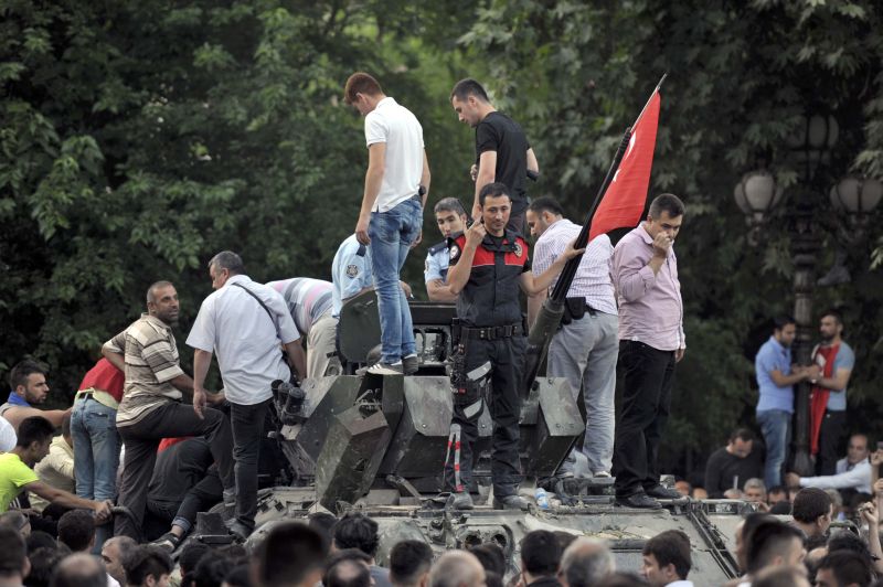 A Turkish policeman and other people stand atop of a military vehicle in Ankara, Turkey July 16, 2016. u00e2u20acu201d Reuters pic