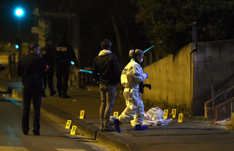 A forensics expert inspects the crime scene of a shooting where a 20-year-old man was killed by a kalashnikov in Marseille, southern France, on March 14, 2016. u00e2u20acu201d AFP pic