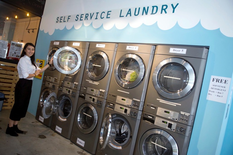 Sip & Spin Laundry Cafe proprietor Jasmine Soh Bee Bee, 27, points out the laundry area during an recent interview with a Bernama reporter at her laundromat cafe. u00e2u20acu201d Bernama pic