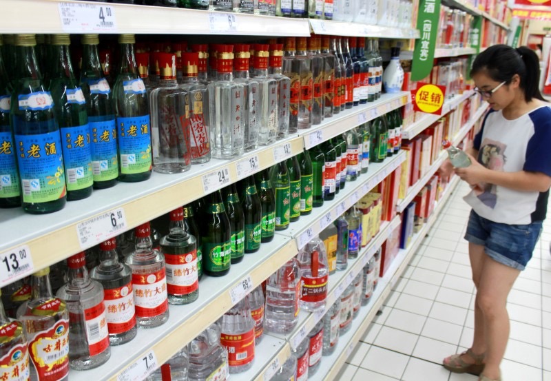 A woman holds a bottle of alcohol product at a supermarket in Nanjing, Jiangsu Province, China, August 6, 2016. Picture taken August 6, 2016. u00e2u20acu201d Reuters pic