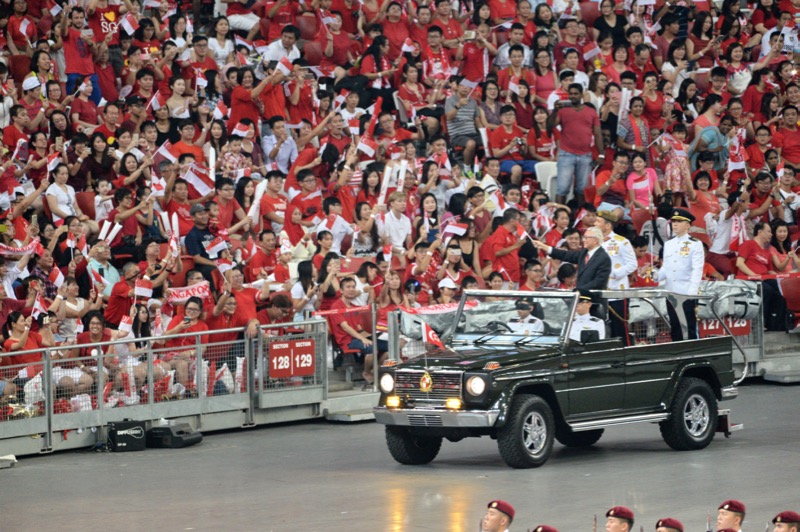 Singapore President Tony Tan Keng Yam (third from right) waves to spectatators from a moving jeep during the National Day celebrations in Singapore on August 9, 2016. u00e2u20acu201d AFP pic