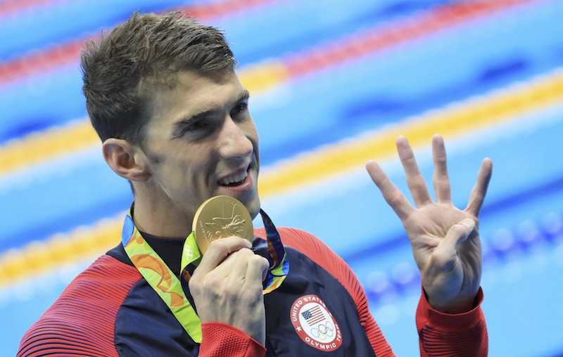 Michael Phelps of USA gestures as he poses with his gold medal after winning the menu00e2u20acu2122s 200m individual medley final at the Olympic Aquatics Stadium in Rio de Janeiro August 11, 2016. u00e2u20acu201d Reuters pic
