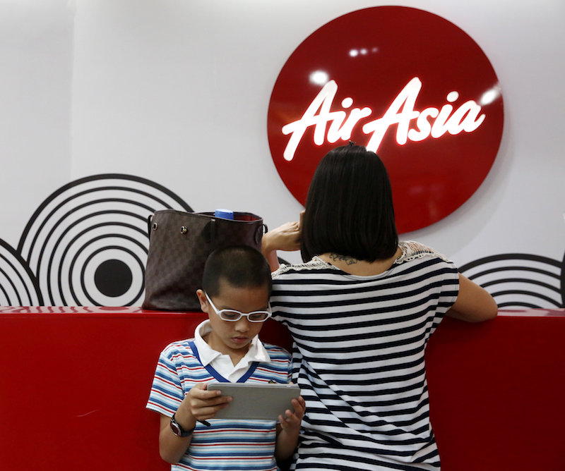 Customers wait at an AirAsia ticket counter at Kuala Lumpur International Airport in Sepang March 7, 2016. u00e2u20acu201d Reuters pic