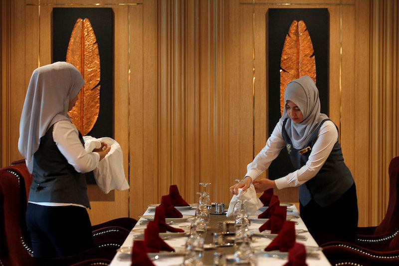 Muslim employees arrange a table at the Al Meroz hotel in Bangkok August 29, 2016. — Reuters pic 