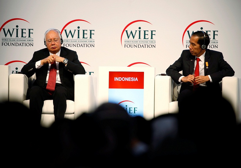 Prime Minister Datuk Seri Najib Razak (left) with Indonesiau00e2u20acu2122s President Joko Widodo listen as Guineau00e2u20acu2122s President Alpha Conde delivers a speech during the opening ceremony of the 12th World Islamic Economic Forum (WIEF) in Jakarta, Indonesia August 2, 