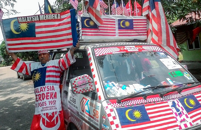 57-year-old army retiree Muhammad Nasir Mustapha poses in front of his van decorated with the Jalur Gemilang, in Tanah Merah Aug 11, 2016. u00e2u20acu201d Bernama pic