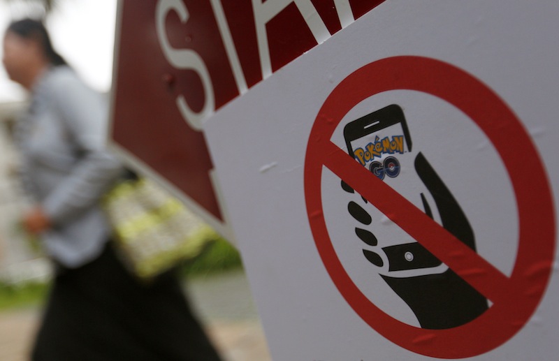 A tourist walks near a sign 'No Pokemon Game Here' at the Tuol Sleng Genocide Museum, also known as the notorious security prison S-21, in Phnom Penh, Cambodia, August 10, 2016. u00e2u20acu201d Reuters pic