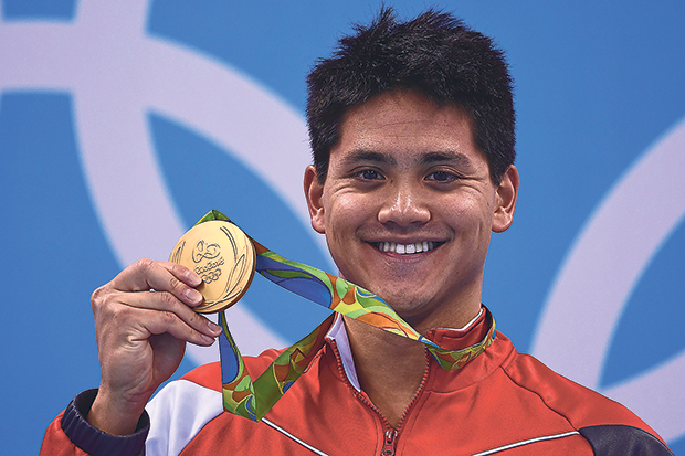 Singapore’s Joseph Schooling poses with his gold medal on the podium of the Men’s 100m Butterfly Final... the country’s first Olympic gold medal, on August 12, 2016.— Picture from AFP