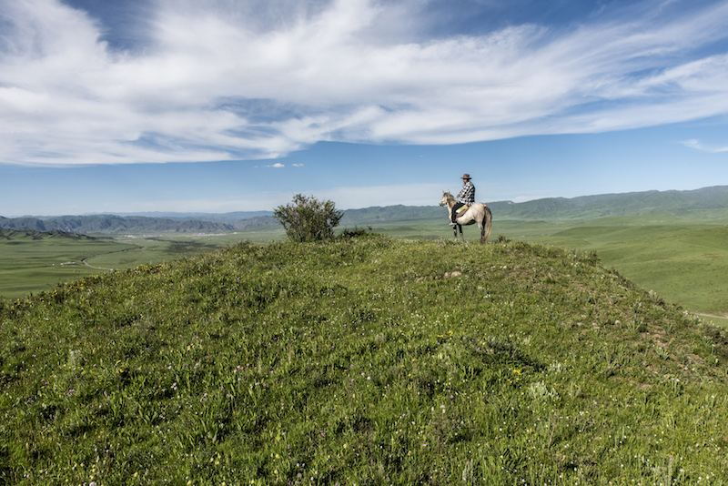 A horse rider on a rise near Norden Camp, a glamorous camping, or ‘glamping,’ experience available on the Sangke Grasslands of the Tibetan plateau in China July 20, 2016. — Picture by Gilles Sabrie/The New York Times