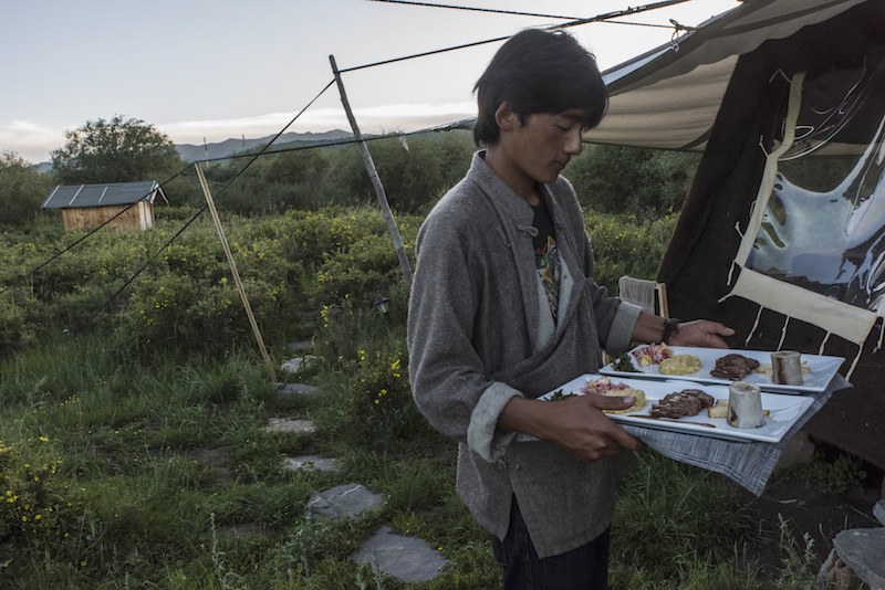 A dinner using local foods, this time including yak meat, is brought to guests at Norden Camp, a glamorous camping, or ‘glamping,’ experience available on the Sangke Grasslands of the Tibetan plateau in China July 20, 2016. — Picture by Gilles Sabrie/The New York Times