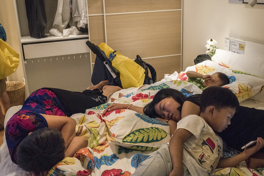 A family rests on a display bed at an Ikea store in Beijing August 27, 2016. — Picture by Gilles Sabrie/The New York Times