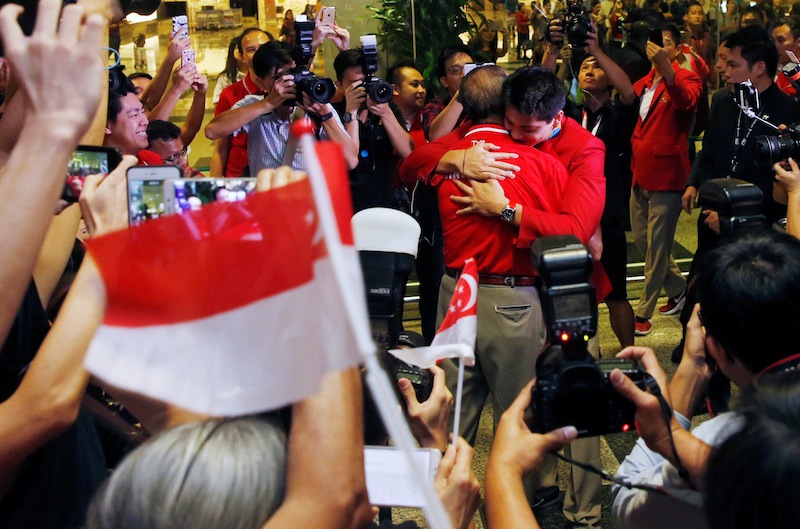 Singapore Olympic gold medallist swimmer Joseph Schooling hugs his father Colin Schooling during a homecoming ceremony at Singapore's Changi Airport August 15, 2016. u00e2u20acu201d Reuters pic
