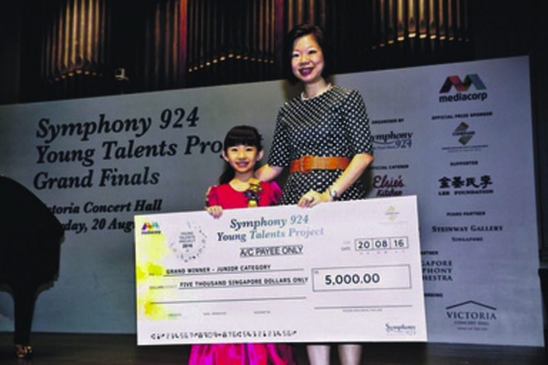 Sim Ann, Senior Minister of State for Ministry of Culture, Community and Youth, with Junior Category Grand Winner Chloe Chua. u00e2u20acu201d Picture courtesy of Symphony 924n