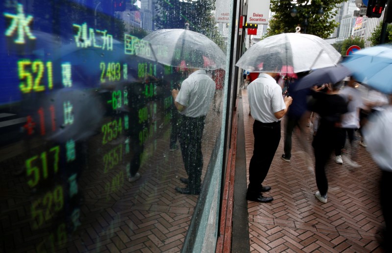 A man stands next to an electronic board showing stock prices in Tokyo, Japan, August 18, 2016. u00e2u20acu201d Reuters pic 