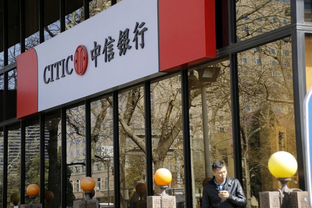 A man stands in front of CITIC bank's branch in Beijing, China, in this March 23, 2016 file photo. u00e2u20acu201d Reuters pic