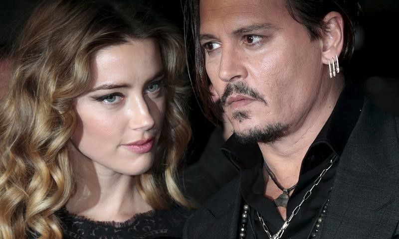 Cast member Johnny Depp and Amber Heard arrive for the British premiere of the film 'Black Mass' in London October 11, 2015. u00e2u20acu201d Reuters pic