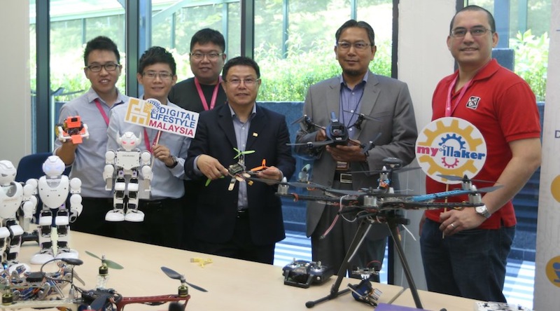 Aisharudding (second from right) and Tay (third from right) show drones that could be used in agriculture. u00e2u20acu201du00c2u00a0Picture by Razak Ghazali