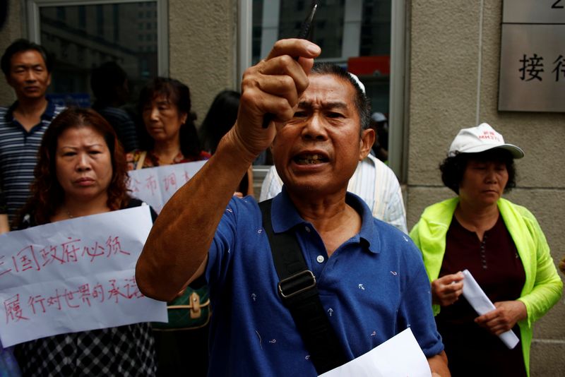 Family members of passengers aboard Malaysia Airlines flight MH370 which went missing in 2014 hold placards during a protest outside the Chinese foreign ministry in Beijing July 29, 2016. u00e2u20acu201d Reuters pic