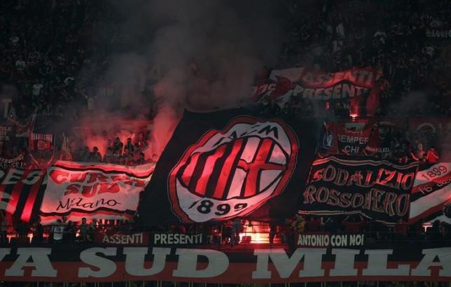 AC Milan fans light flares during the teamu00e2u20acu2122s Italian Seria A soccer match against Inter Milan at San Siro stadium in Milan May 4, 2014. uk.reuters.com