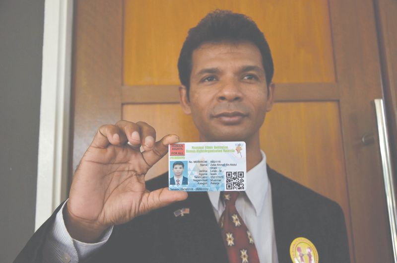 Zafar shows one of the cards produced by Merhom. He argues the cards are needed to provide the community with some form of identification. u00e2u20acu201d  Malay Mail pic