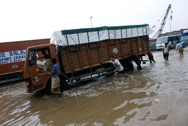 People push a stranded truck in a waterlogged highway after heavy rains in Gurugram, previously known as Gurgaon, on the outskirts of New Delhi July 29, 2016. u00e2u20acu201d Reuters pic