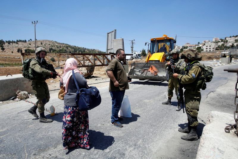 Israeli army soldiers search Palestinians at a checkpoint during clashes in the West Bank Al-Fawwar refugee camp, south of Hebron August 16, 2016. u00e2u20acu201d Reuters pic