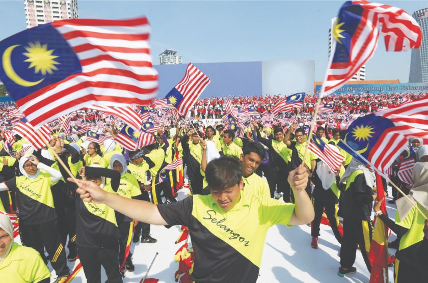 Children wave the Jalur Gemilang during the Merdeka Day celebrations last year. — Picture by Zuraneeza Zulkifli.