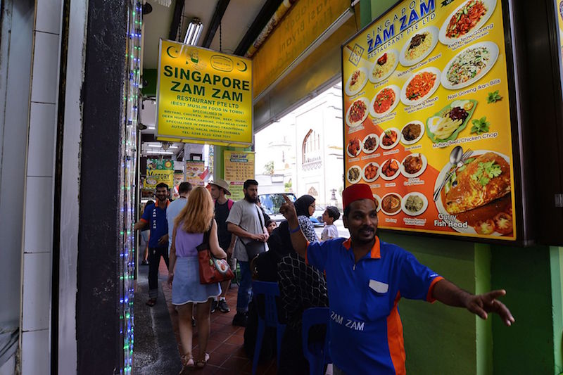 A staff advertising to passers-by what to eat at the Singapore Zam Zam Restaurant. — TODAY pic