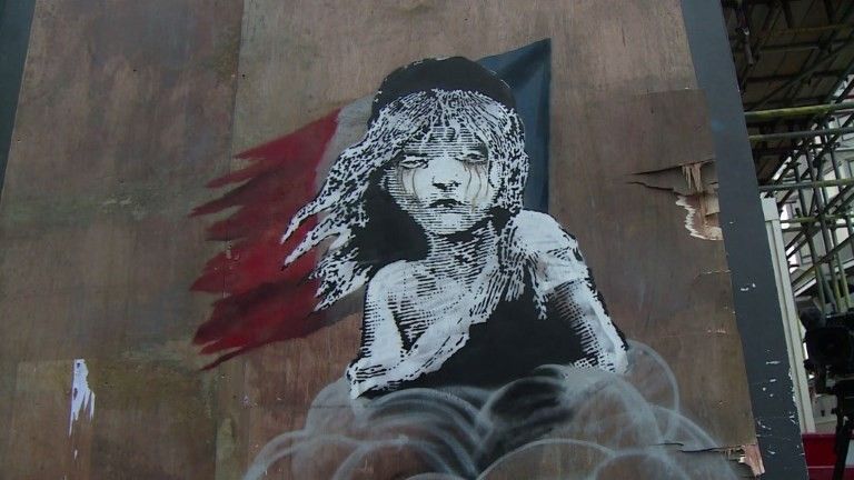An artwork by Banksy in London criticises the treatment of migrants in Calais.
