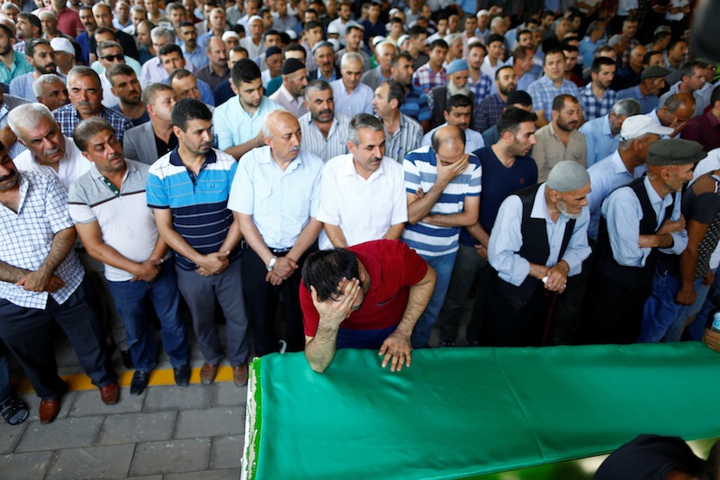 A family member of a victim of a suicide bombing at a wedding celebration mourn over a coffin during a funeral ceremony in the southern Turkish city of Gaziantep, Turkey, August 21, 2016. u00e2u20acu201d Reuters pic