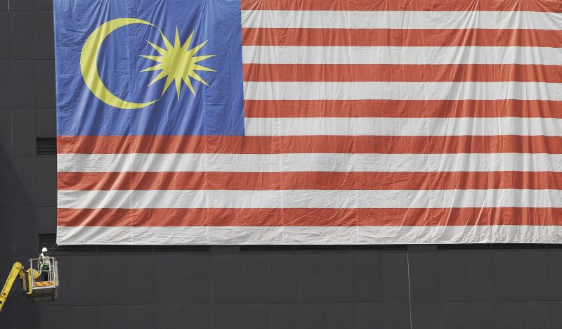 Workers are seen hard at work hanging up the national flag outside a building ahead of the National Day celebrations at the end of this month, Kuala Lumpur August 18, 2016. u00e2u20acu2022 Picture by Yusof Mat Isa