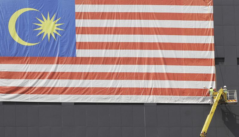 Workers are seen hard at work hanging up the national flag outside a building ahead of the National Day celebrations at the end of this month, Kuala Lumpur August 18, 2016. u00e2u20acu2022 Picture by Yusof Mat Isa