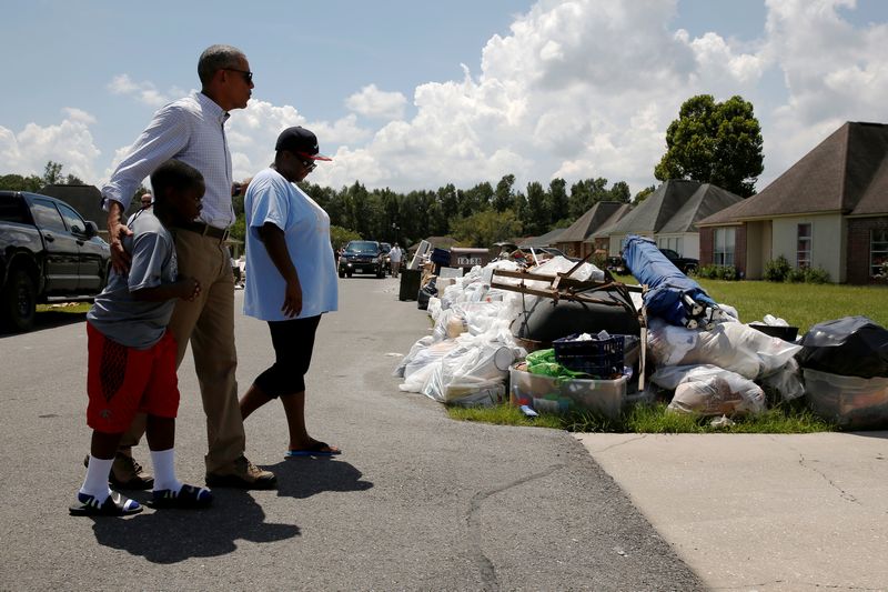 US President Barack Obama greets a family as he tours houses in a flood-affected neighbourhood in Zachary, Louisiana August 23, 2016. u00e2u20acu201d Reuters pic