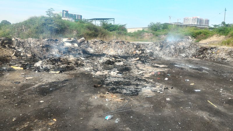 Smoke from a fresh pile of rubbish burned the previous night August 13, 2016. u00e2u20acu201d Picture by Ram Anand