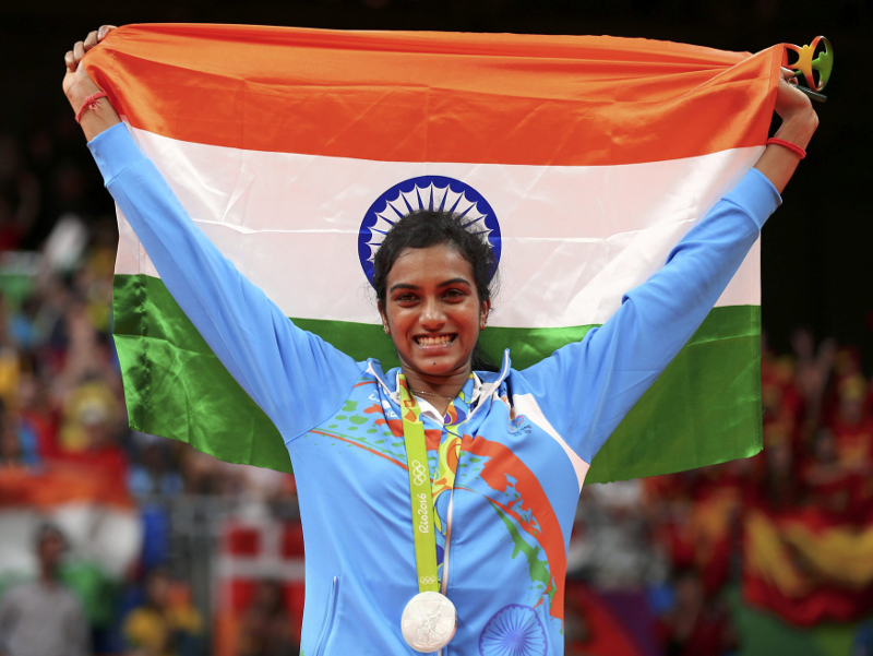 Silver medallist P.V. Sindhu of India poses with an Indian national flag after her match against Carolina Marin of Spain in the 2016 Rio Olympics badminton womenu00e2u20acu2122s singles final in Rio de Janeiro August 19, 2016. u00e2u20acu201d Reuters pic