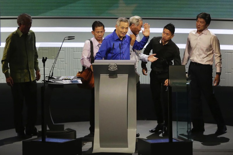 Prime Minister Lee Hsien Loong being helped off the stage by Defence Minister Ng Eng Hen after he took ill while delivering the rally speech at the ITE College Central Campus. u00e2u20acu201d Picture courtesy of Wee Teck Hian