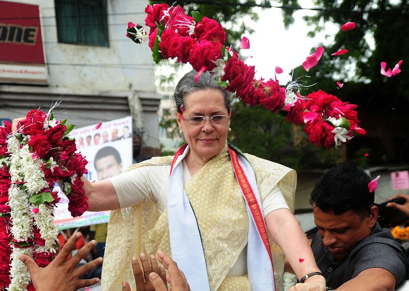 Indian Congress Party president Sonia Gandhi receives floral tributes during a roadshow in Varanasi on August 2, 2016, ahead of 2017 Uttar Pradesh State Assembly elections. u00e2u20acu201d AFP pic 