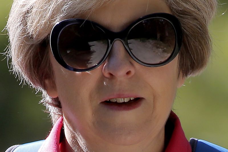Britain's Prime Minister Theresa May walks in a forest at the start of a summer holiday in the Alps, in Switzerland August 12, 2016. u00e2u20acu201d Reuters pic