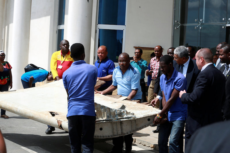 Shippers carry an aircraft wing suspected to be a part of missing Malaysia Airlines jet MH370 discovered on the island of Pemba, off the coast of Tanzania, in Dar es Salaam July 15, 2016. u00e2u20acu201d Reuters pic