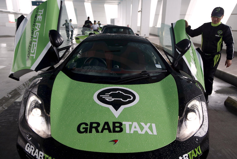 A driver checks his McLaren taxi after a photoshoot for taxi-booking app GrabTaxiu00e2u20acu2122s fleet of seven luxury cars in Singapore September 15, 2015. u00e2u20acu201d Reuters pic