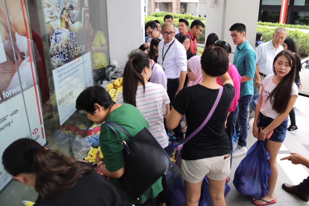 The crowd on a weekday morning, with some buying bags of the soft toys.
