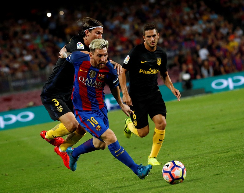 Barcelonau00e2u20acu2122s Lionel Messi and Atletico Madridu00e2u20acu2122s Filipe Luis in action during their Spanish La Liga match at Camp Nou Stadium in Barcelona September 21, 2016. u00e2u20acu201d Reuters pic