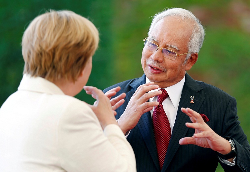 German Chancellor Angela Merkel and Prime Minister Datuk Seri Najib Razak talk about an instrument after reviewing the honour guard during a welcoming ceremony at the chancellery in Berlin, Germany September 27, 2016. u00e2u20acu201d Reuters pic