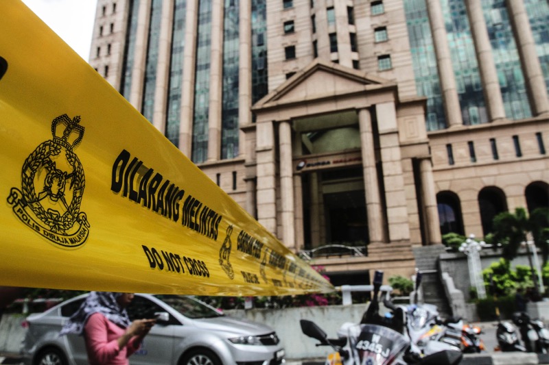 The road that provides access to a nearby Hindu temple and Bursa Malaysia is seen cordoned off by police with yellow tape, September 30, 2016. u00e2u20acu201d Photo by Yusof Mat Isa