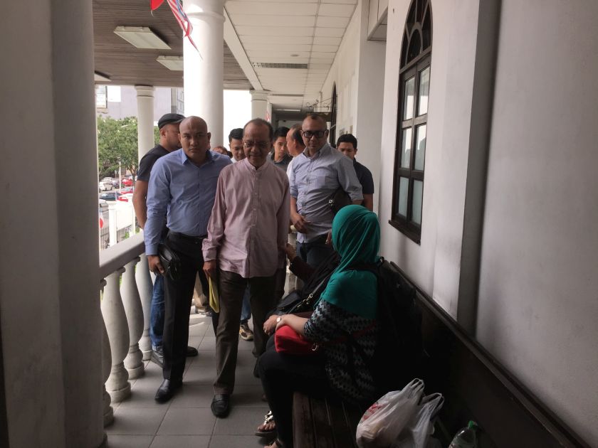 Former Sabah Land Development Board general manager George @Juaari Majid being accompanied to the Sessions Court in Kota Kinabalu on September 20, 2016. u00e2u20acu2022 Picture by Julia Chan