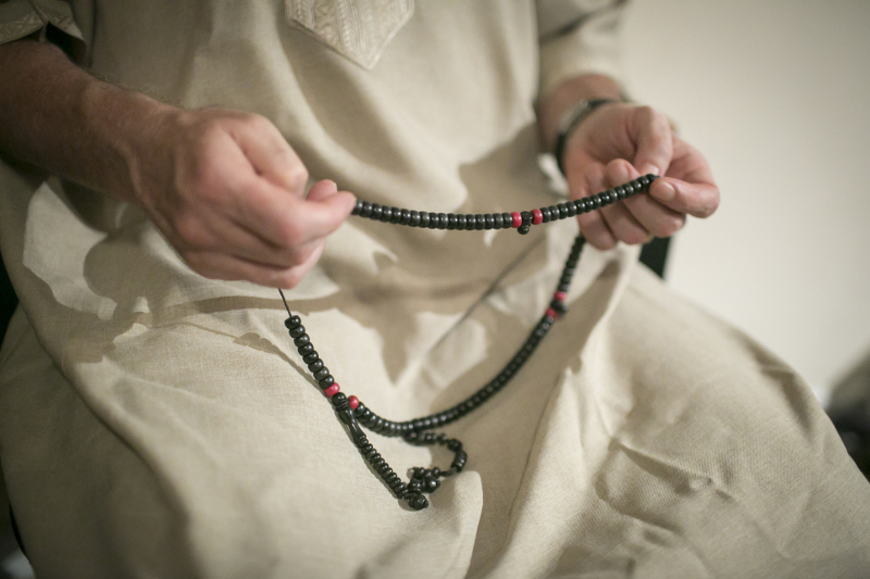 Abdul Latif holds prayer beads and chants during a gathering of fellow Sufis at his apartment in New York, August 4, 2016.